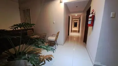 a hallway of a hospital with chairs and plants at Hospedaje Las Vegas in San Vicente de Cañete