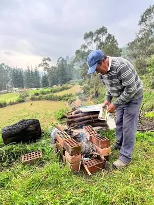 a man standing next to a pile of red brick at Swiss Chalet en Canta in San Miguel