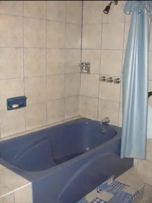 a blue bath tub in a bathroom with a shower at Swiss Chalet en Canta in San Miguel