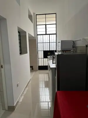 a kitchen with a black refrigerator in a room at Albano apartamento 3 en tu refugio Chosica in Chosica