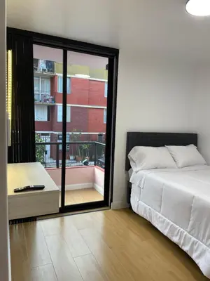 a bedroom with a bed and a large window at Habitaciones casa Bella in Lima