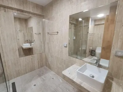 a bathroom with a sink and a mirror at Hotel Boutique La Angostura II in Ica