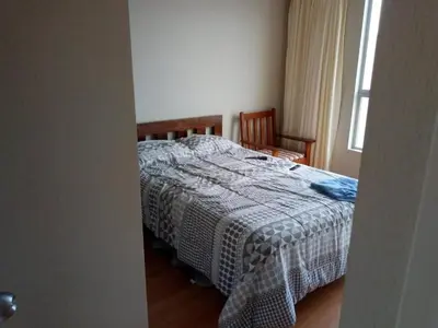 a bedroom with a bed with a blanket on it at Claudio in Lima