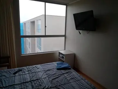 a bedroom with a bed and a flat screen tv at Claudio in Lima
