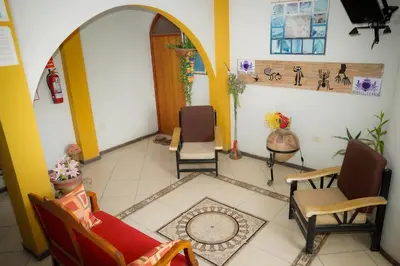 a living room with two chairs and a table at Hostal Luren - Parking in Nazca