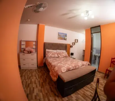 a bedroom with a bed and a dresser in it at Hostal Luren - Parking in Nazca