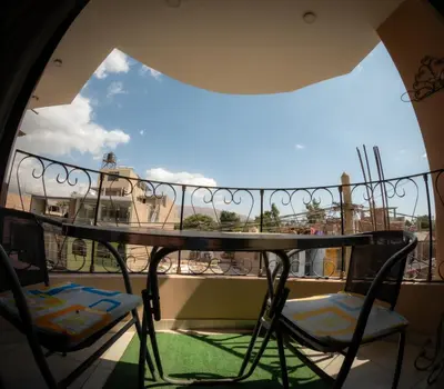 a balcony with a table and two chairs at Hostal Luren - Parking in Nazca