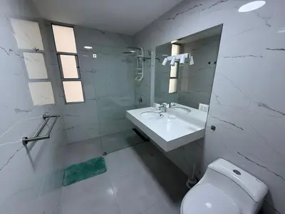 a white bathroom with a sink and a toilet at Dpto Benavides la paz miraflores in Lima
