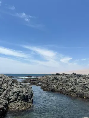 a rocky shoreline with a body of water at Tanaka Beach House in Tanaca