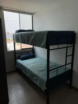 two bunk beds in a room with a window at Departamento Prescott in Lima