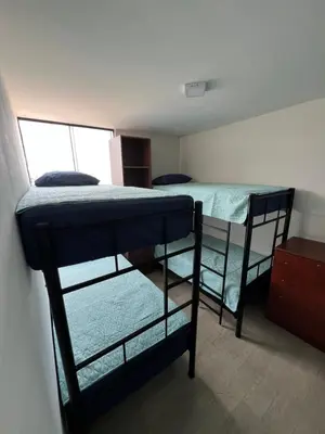 a room with two bunk beds in a room at Departamento Prescott in Lima
