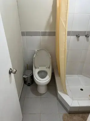 a small bathroom with a toilet and a shower at Departamento Prescott in Lima