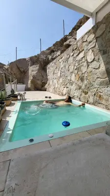 a man in a swimming pool with a frisbee at Little Oasis in Lima penthouse with pool, Grill, nice view, gated community in Ciudad de Dios