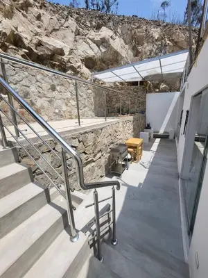 a building with stairs and a stone wall at Little Oasis in Lima penthouse with pool, Grill, nice view, gated community in Ciudad de Dios