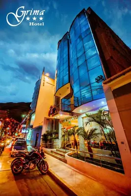 a motorcycle parked on a street in front of a building at Grima Hotel in Huánuco
