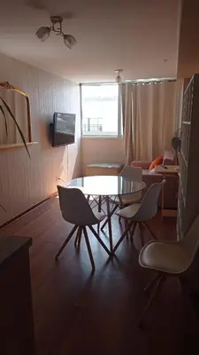 a living room with a table and chairs and a couch at Departamento en Santa Catalina in Lima