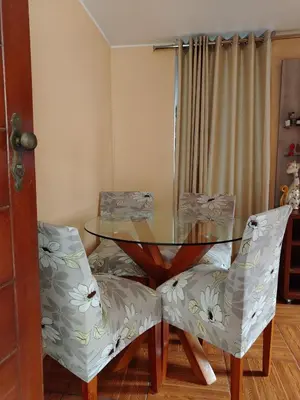 a dining room with a glass table and two chairs at Departamento en Sjl in Lima