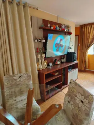 a living room with a flat screen tv and a couch at Departamento en Sjl in Lima