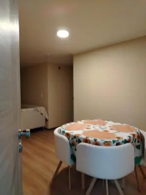 a room with a table and two chairs and a bed at Depa con piscina 2025 in Lima