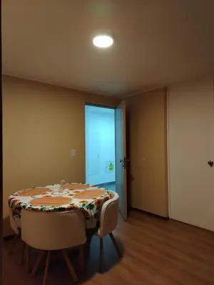 a dining room with a table and two chairs at Depa con piscina 2025 in Lima