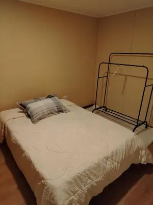 a bedroom with a bed with a metal frame at Depa con piscina 2025 in Lima