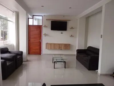 a living room with two couches and a flat screen tv at Exclusivo Depa Cerca Precio Uno para 10 in La Merced