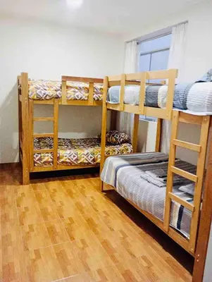 two bunk beds in a room with a wooden floor at Exclusivo Depa Cerca Precio Uno para 10 in La Merced