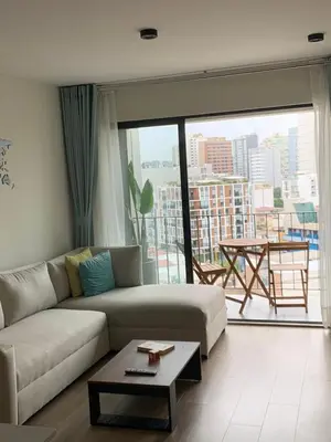a living room with a couch and a large window at Full Depa en Miraflores in Lima