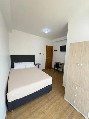 a bedroom with a large bed and a desk at Hotel Costa Arena in Supe