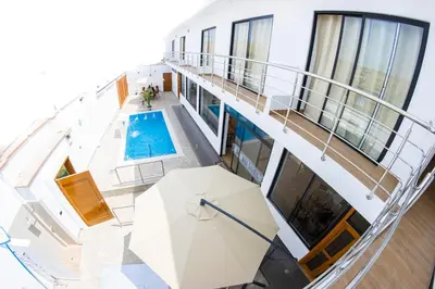 an overhead view of a building with a swimming pool at Hotel Costa Arena in Supe