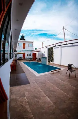 a swimming pool on the roof of a house at Hotel Costa Arena in Supe