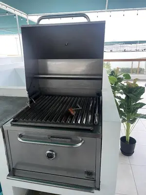 a barbecue grill sitting in a room with a plant at Casa de Playa Hawi in San Antonio