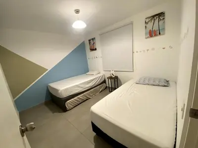 a room with two beds and a window in it at Casa de Playa Hawi in San Antonio