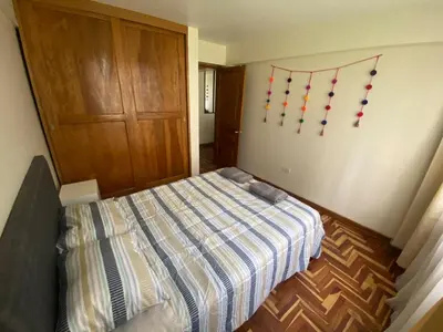 a bedroom with a bed with christmas decorations on the wall at Family-friendly apartment! in Cusco