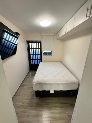a bedroom with a bed in the middle of a room at Miraflores Mini Apartment in Lima