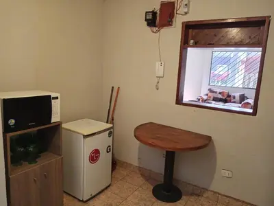 a small room with a table and a microwave at Casa Halcones Huachipa Familia & Eventos in Lima