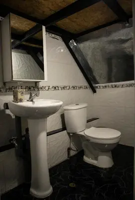 a bathroom with a toilet and a sink at La Almudena hogar tranquilo y acogedor in Cusco