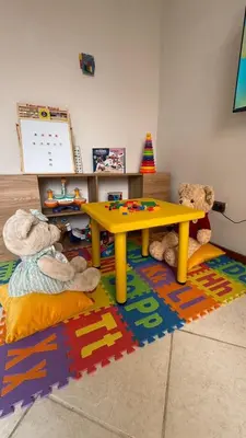 a room with a yellow table and two teddy bears at Casa Amplia en Miraflores in Lima