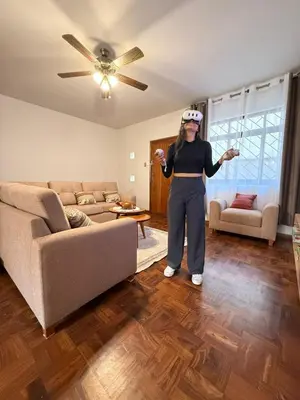 a woman standing in a living room playing a video game at Casa Amplia en Miraflores in Lima