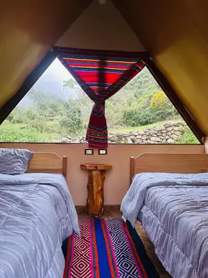 a room with two beds and a window at Salkantay Glamp in Colcapampa