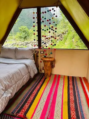 a room with a bed and a large window at Salkantay Glamp in Colcapampa