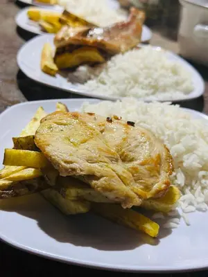 a white plate of food with rice and meat at Salkantay Glamp in Colcapampa