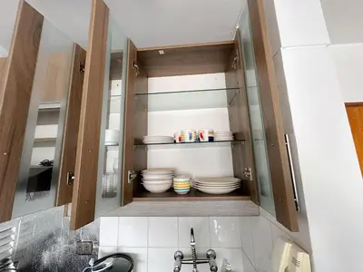 a kitchen with a sink and some dishes in a cabinet at Miraflores 1 habitación in Lima