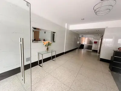 a room with a vase of flowers on a glass table at Miraflores 1 habitación in Lima