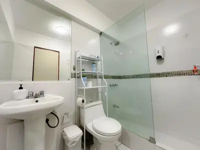 a bathroom with a toilet and a sink and a shower at Miraflores 1 habitación in Lima