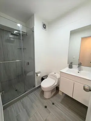 a bathroom with a shower and a toilet and a sink at Elegante Departamento vista al mar en Lima in Lima