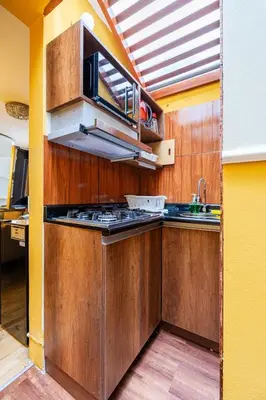 a kitchen with a stove and a sink in it at Classy Andino & primer piso, 2 dormitorios in Lima