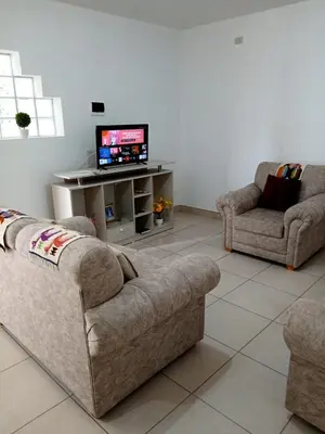 a living room with two couches and a flat screen tv at Apartamento entero en Ayacucho in Ayacucho