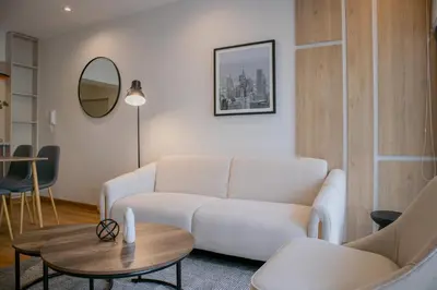 a living room with a white couch and a table at Aguirre By Wynwood House in Lima