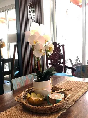 a table with a vase of flowers on a table at Casa de playa Bujama, Mala, Asia, Lima, Moravia II in Bujama Baja